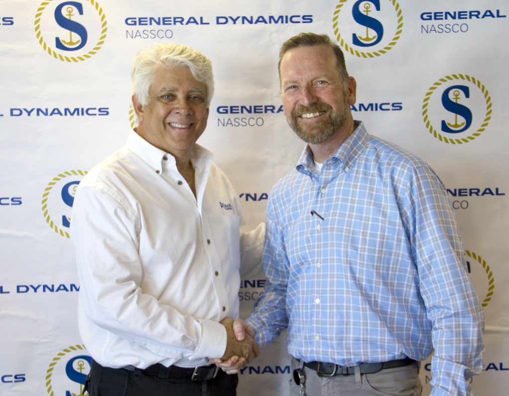 Tom Denning, of SEA-Vista LLC, and Bill Cuddy for General Dynamics NASSCO, make the delivery of the Constitution official.