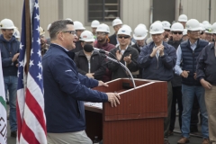 Kevin Graney, President of General Dynamics NASSCO, addresses a crowd of shipbuilders as the company commissioned a new panel line in the San Diego shipyard.