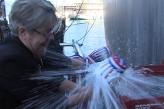 Sponsors Travie Ross and Tracie Ross break a bottle of champagne during the christening of the USNS Hershel "Woody" Williams.
